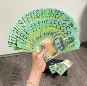 Lady holding stack of counterfeit 100 Australian dollars showing realistic fake AUD notes for sale in Sydney