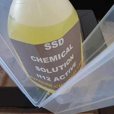 SSD chemical solution laboratory products including brown liquid in bottles and activation powder for cleaning defaced banknotes